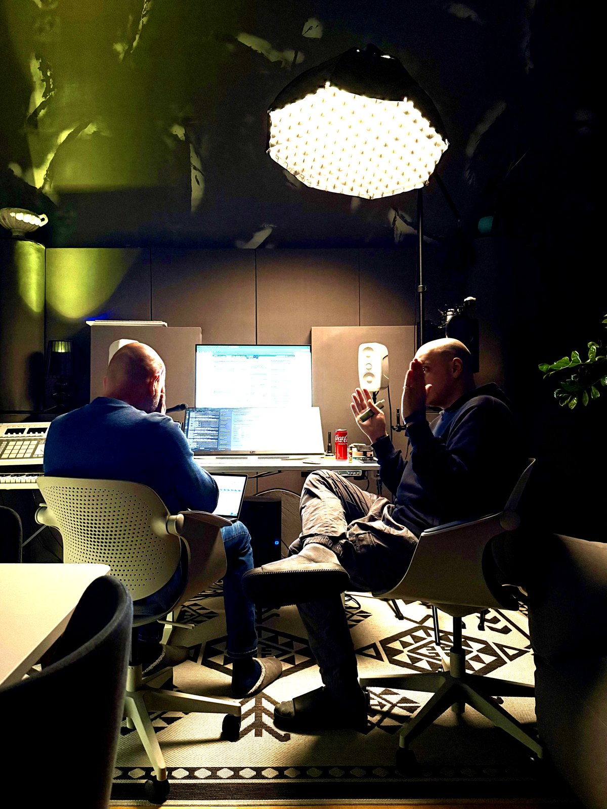 Two founders working under a single light in the studio