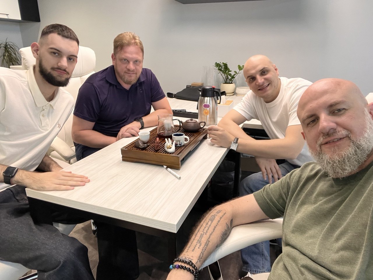 Four members of the Psynex team around a tea table